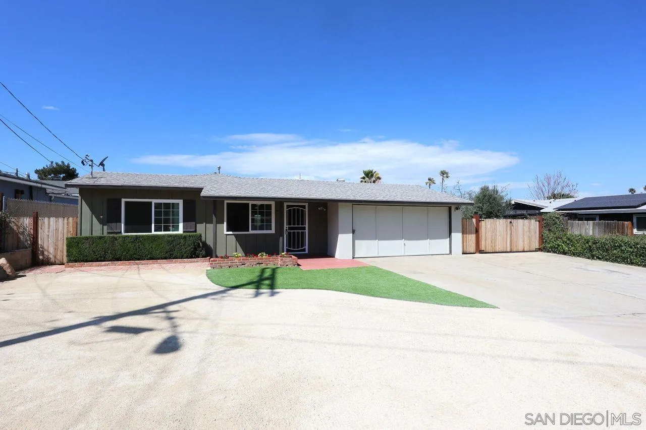 11102 Shadow Hill Way Santee, CA 92071 - Photo 2 of 30 a front view of a house with a yard and garage