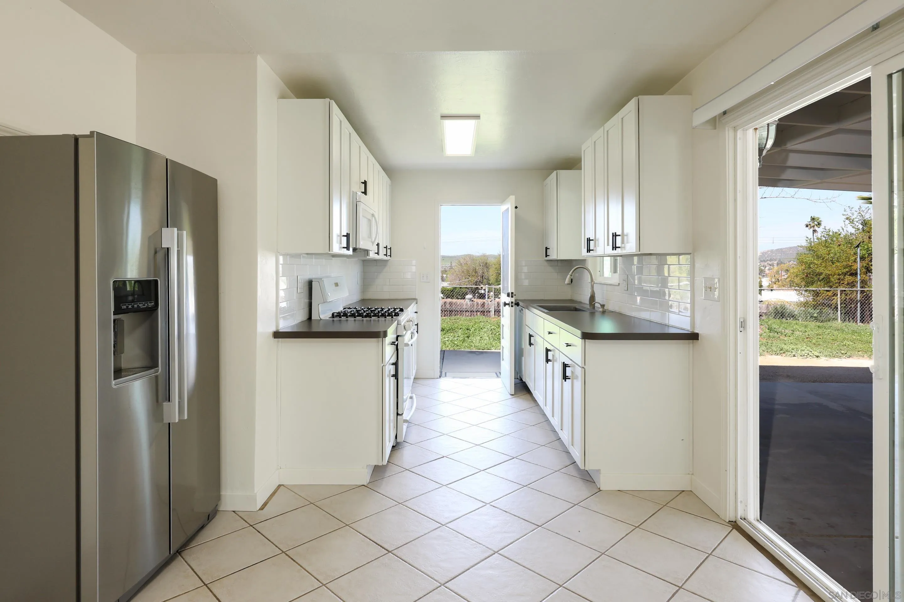 11102 Shadow Hill Way Santee, CA 92071 - Photo 8 of 30 a kitchen with stainless steel appliances granite countertop a refrigerator a stove and a refrigerator