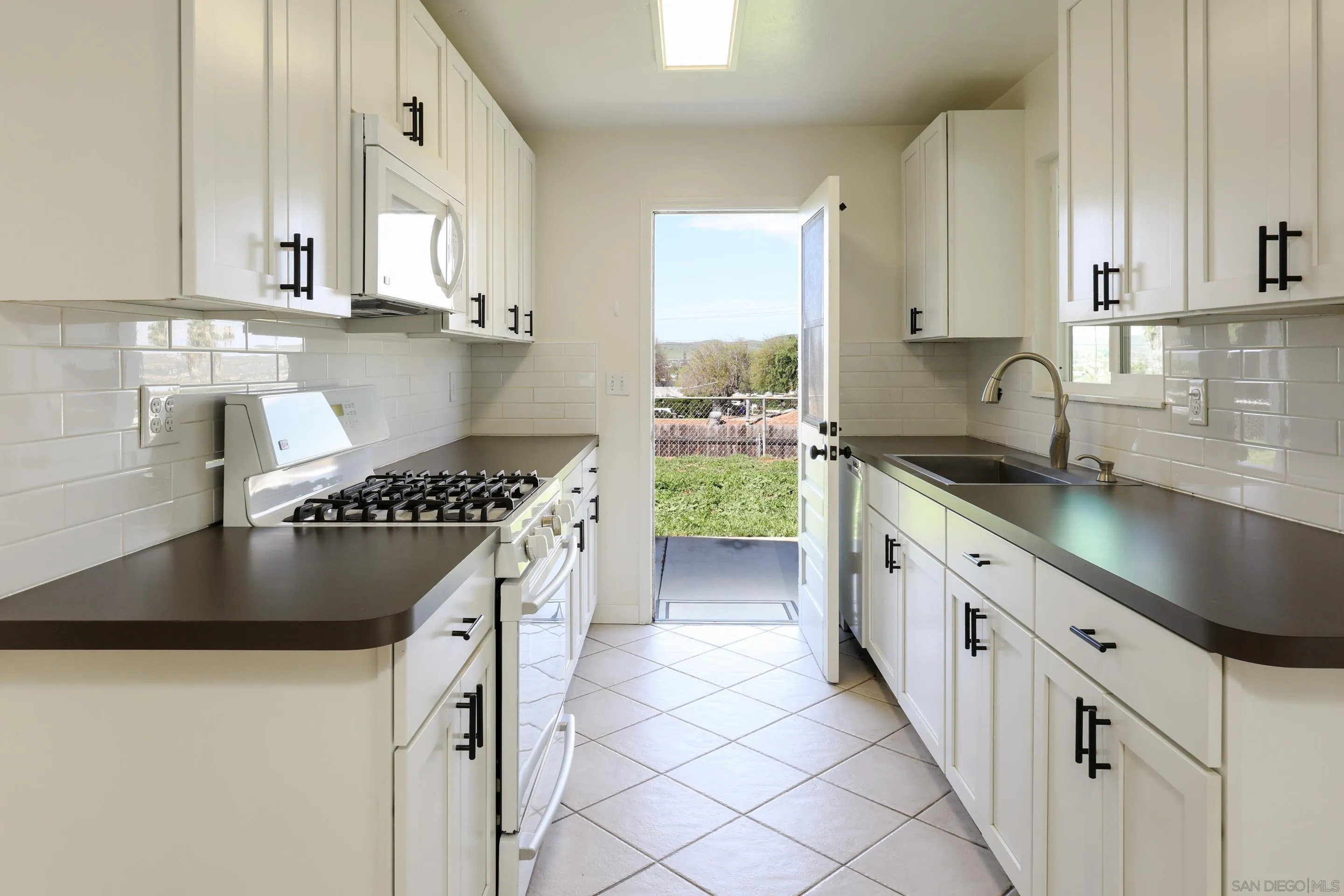 11102 Shadow Hill Way Santee, CA 92071 - Photo 9 of 30 a kitchen with granite countertop a sink a stove and refrigerator