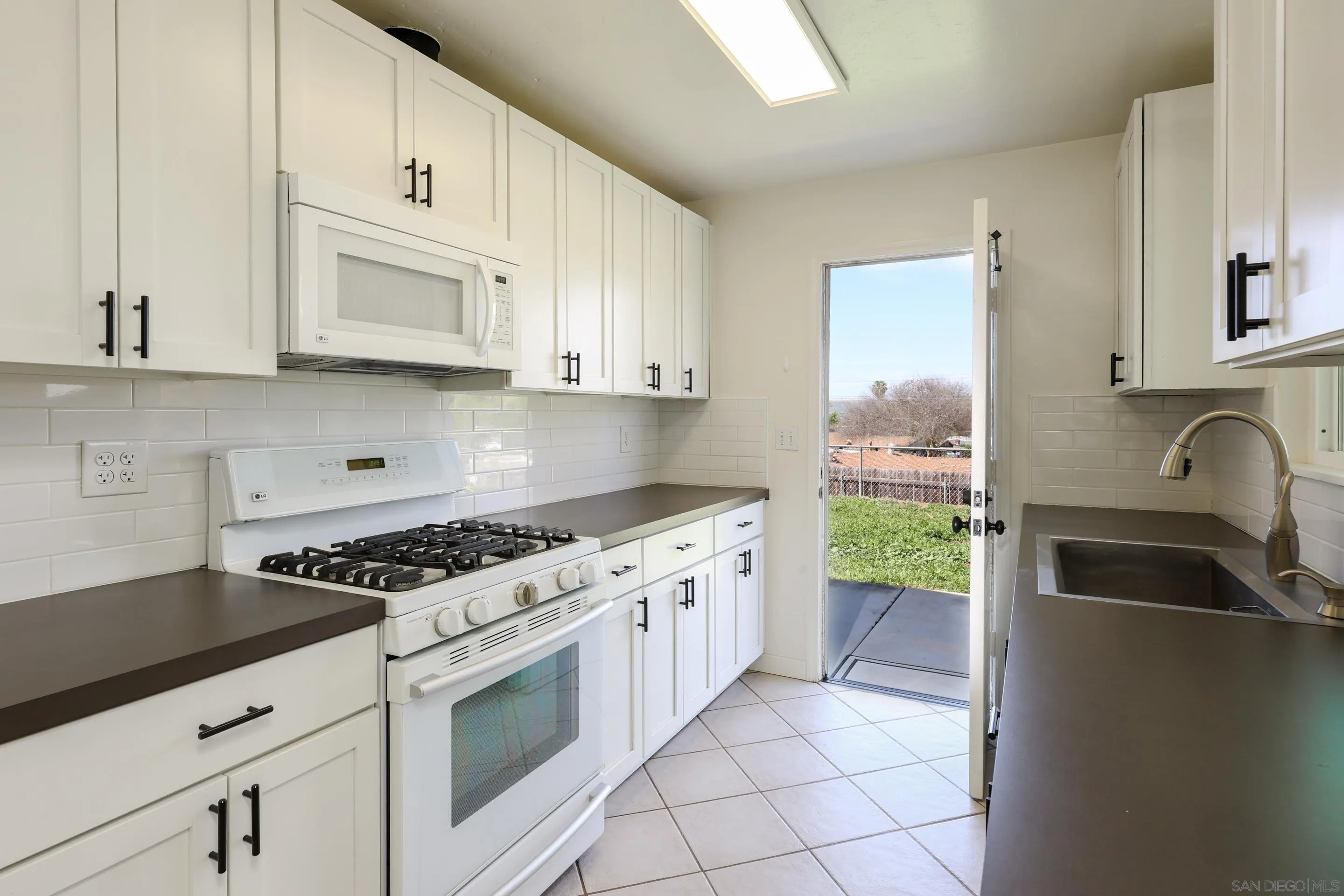 11102 Shadow Hill Way Santee, CA 92071 - Photo 10 of 30 a kitchen with granite countertop a sink stove top oven and cabinets