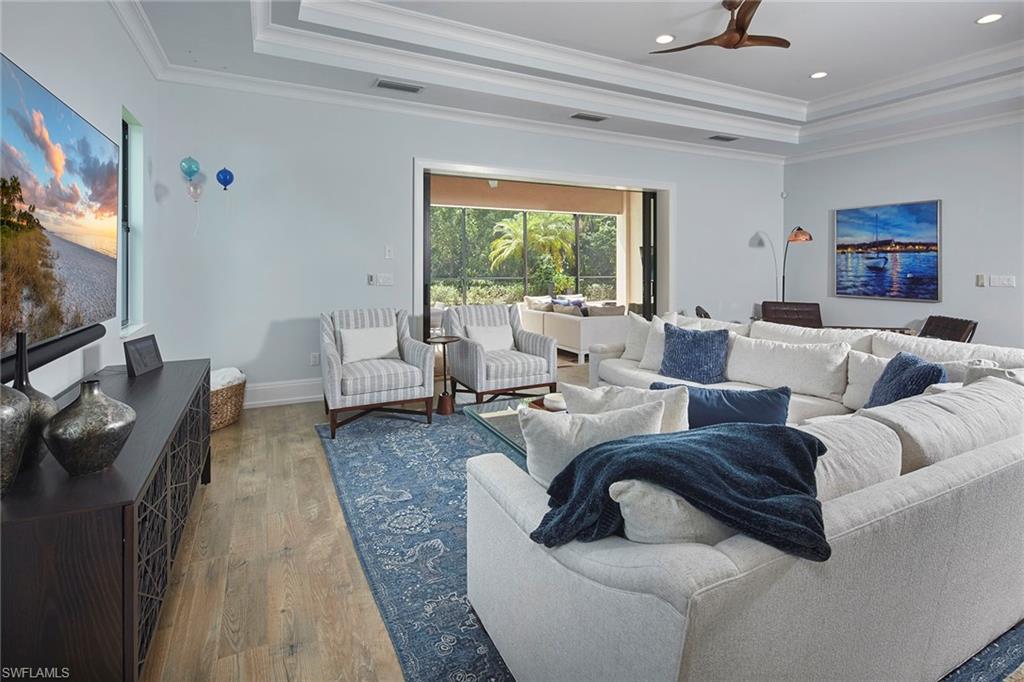 2863 Coco Lakes Drive Naples, FL 34105 - Photo 11 of 39 a living room with furniture and a flat screen tv