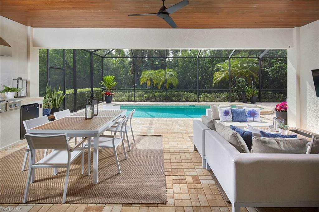 2863 Coco Lakes Drive Naples, FL 34105 - Photo 12 of 39 a outdoor space with patio the couches and dining table with garden view