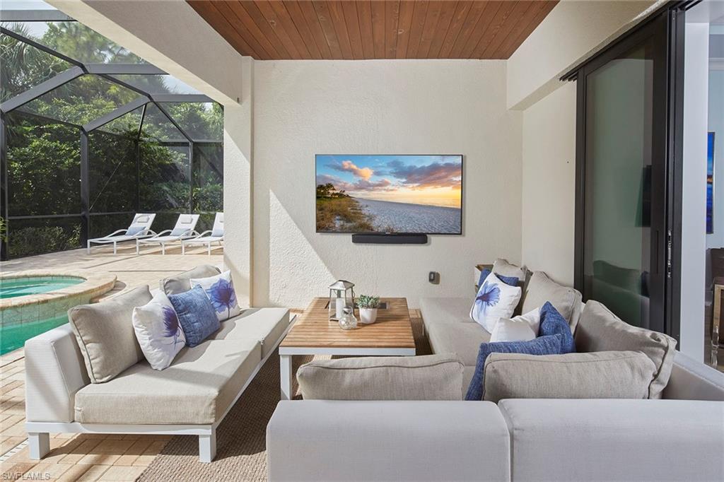 2863 Coco Lakes Drive Naples, FL 34105 - Photo 14 of 39 a living room with furniture and a flat screen tv