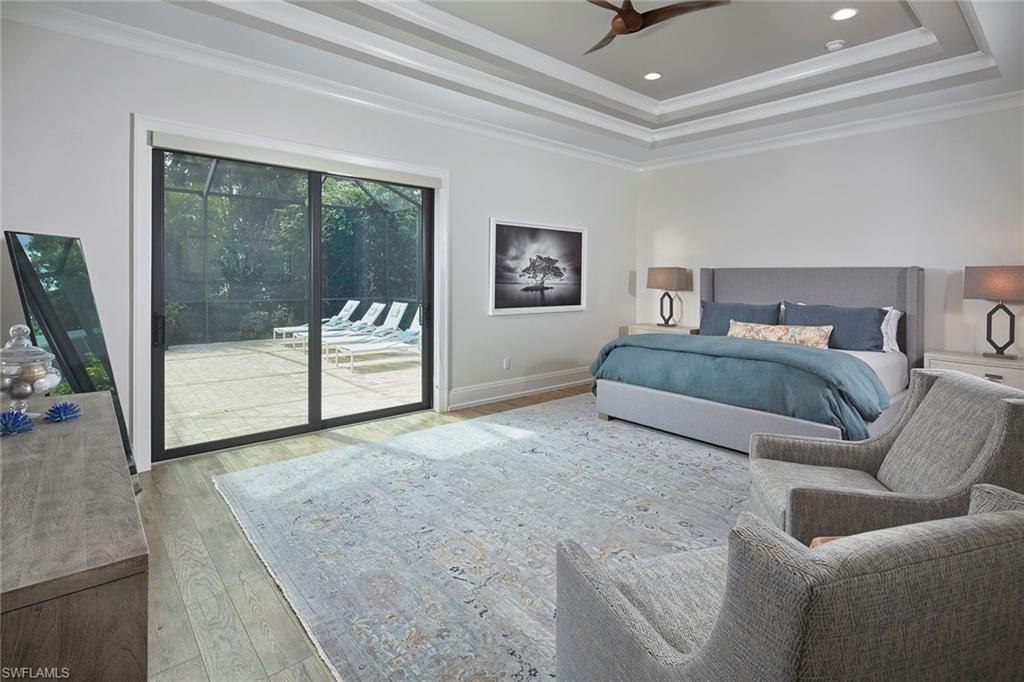 2863 Coco Lakes Drive Naples, FL 34105 - Photo 17 of 39 a living room with a couch and a flat screen tv