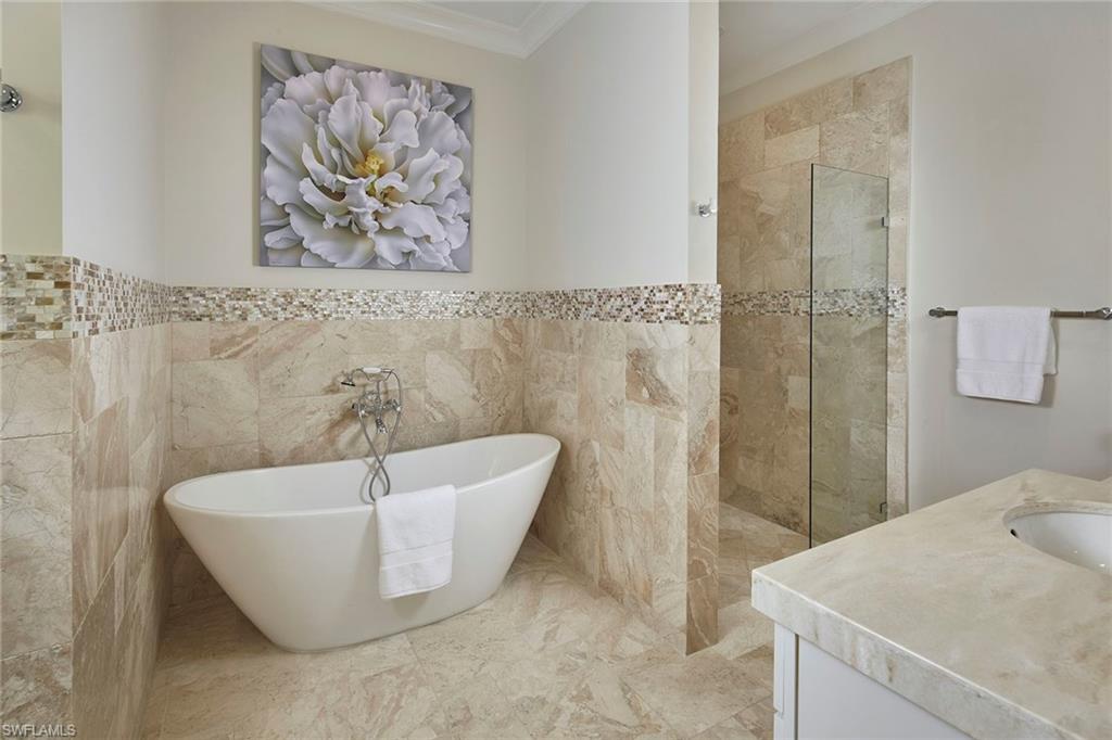 2863 Coco Lakes Drive Naples, FL 34105 - Photo 20 of 39 a bathroom with a bathtub and shower