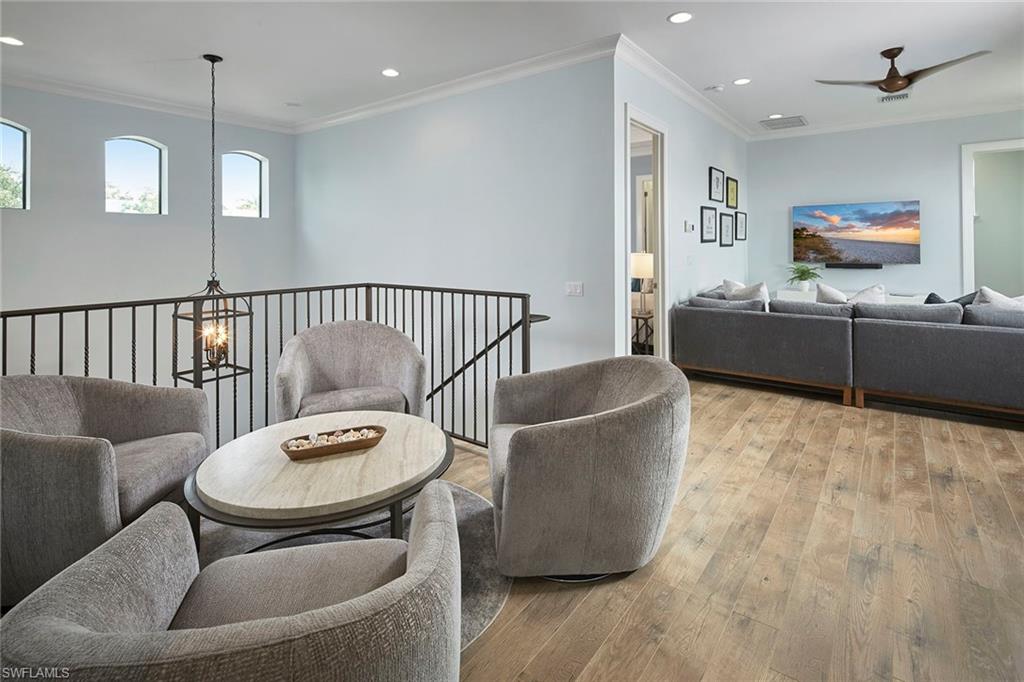 2863 Coco Lakes Drive Naples, FL 34105 - Photo 26 of 39 a living room with furniture and a wooden floor