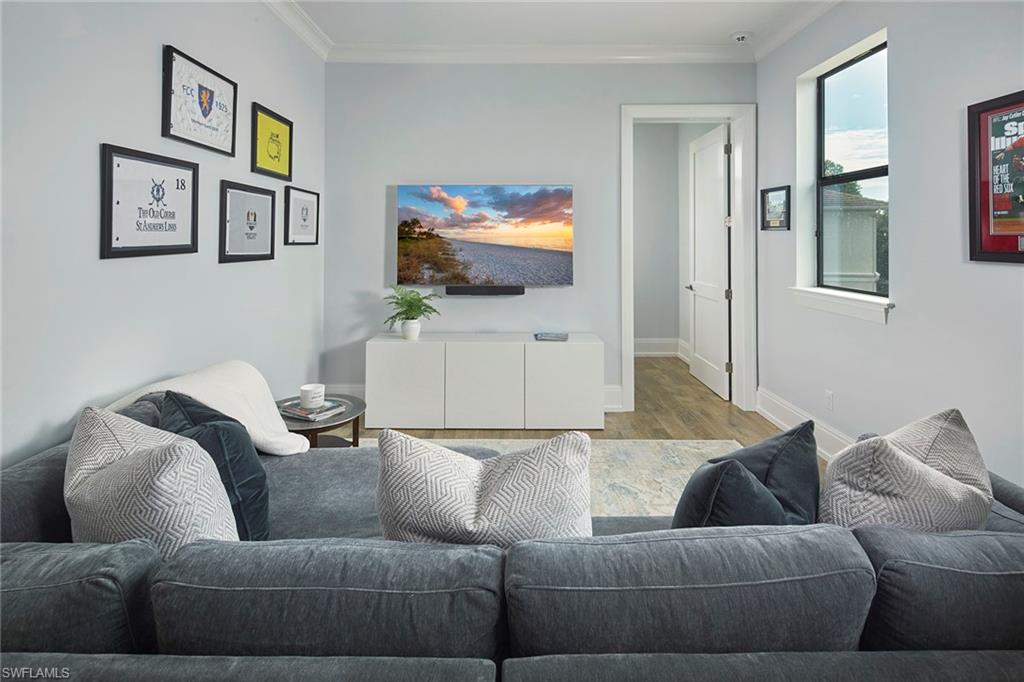 2863 Coco Lakes Drive Naples, FL 34105 - Photo 27 of 39 a living room with furniture and a flat screen tv
