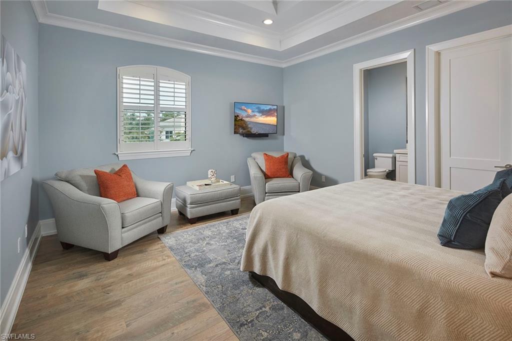 2863 Coco Lakes Drive Naples, FL 34105 - Photo 29 of 39 a bedroom with bed and a couch