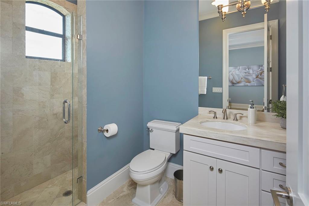 2863 Coco Lakes Drive Naples, FL 34105 - Photo 30 of 39 a bathroom with a sink a toilet and shower