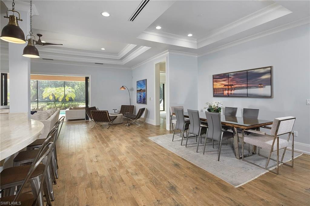 2863 Coco Lakes Drive Naples, FL 34105 - Photo 7 of 39 a living room with furniture and a wooden floor