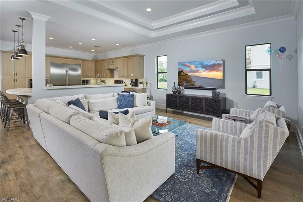 2863 Coco Lakes Drive Naples, FL 34105 - Photo 9 of 39 a living room with furniture and a flat screen tv