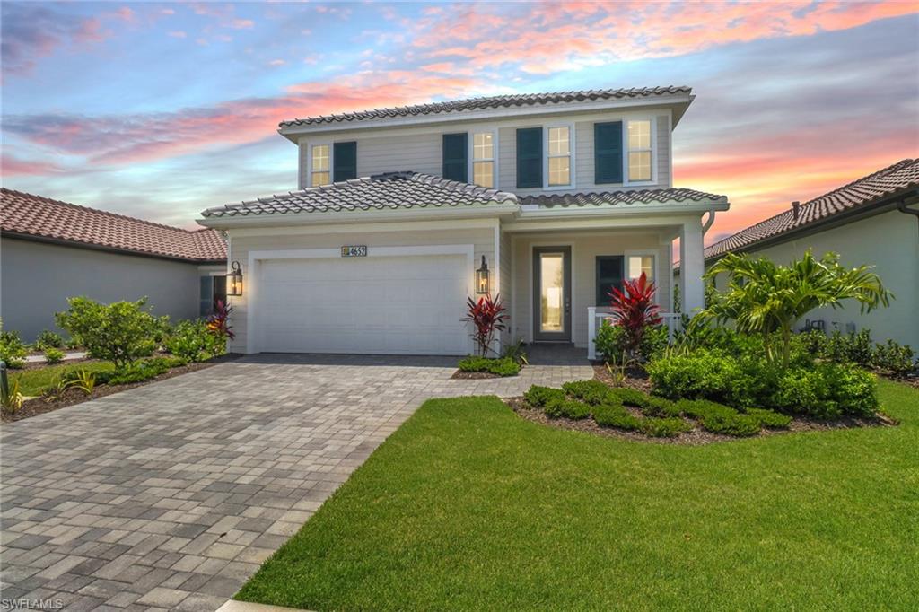 4652 Centaurus Circle Naples, FL 34120 - Photo 2 of 45 Mediterranean / spanish-style house with a tiled roof, decorative driveway, a garage, and a porch