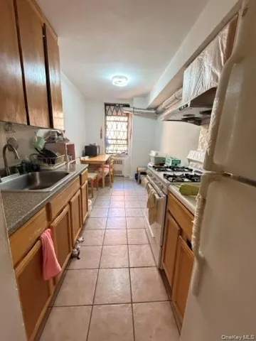 a kitchen with stainless steel appliances a sink stove top oven and cabinets