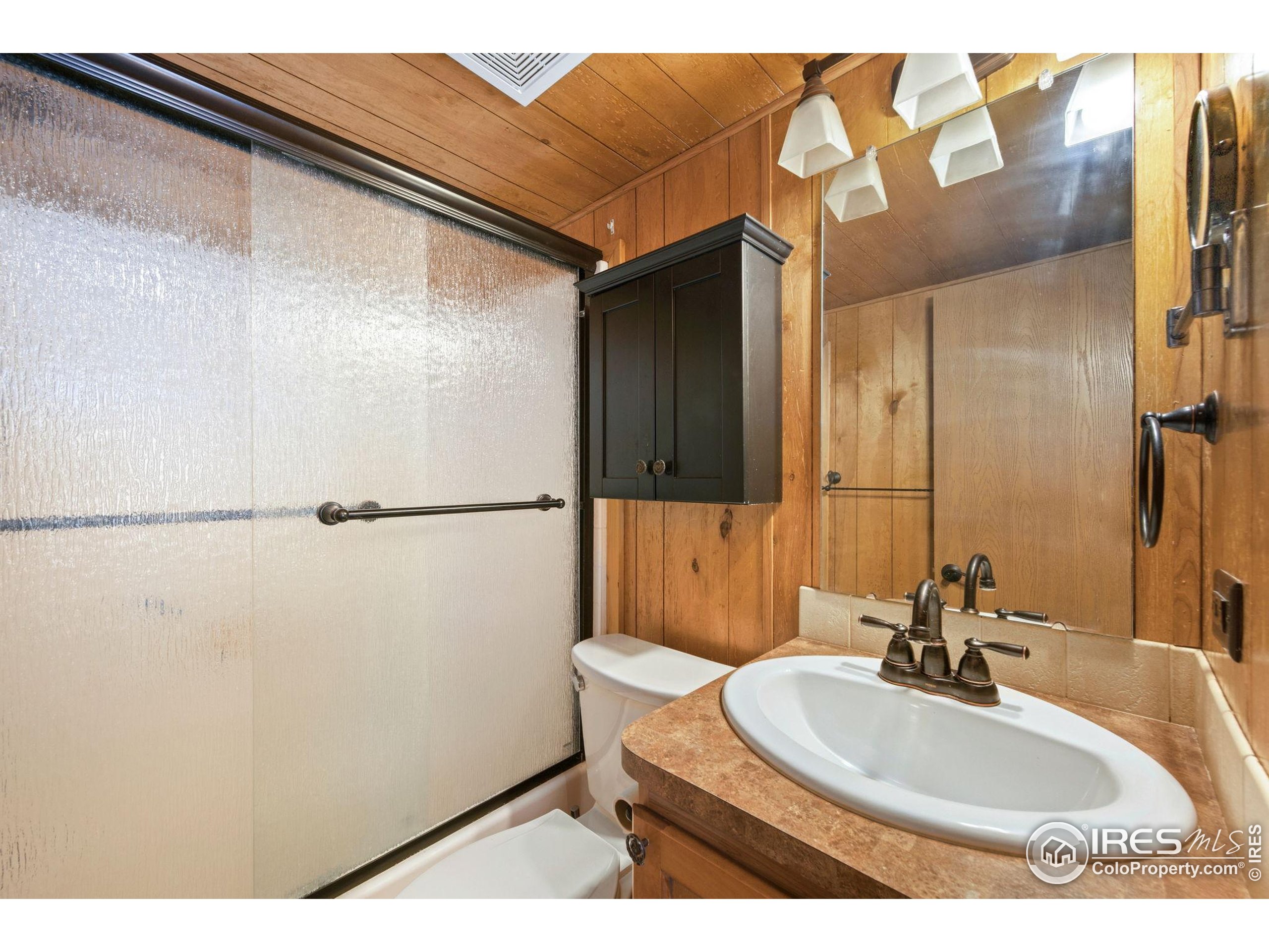 2444 River Rim Road, Unit 417 Loveland, CO 80537 - Photo 11 of 21 a bathroom with a sink and a mirror
