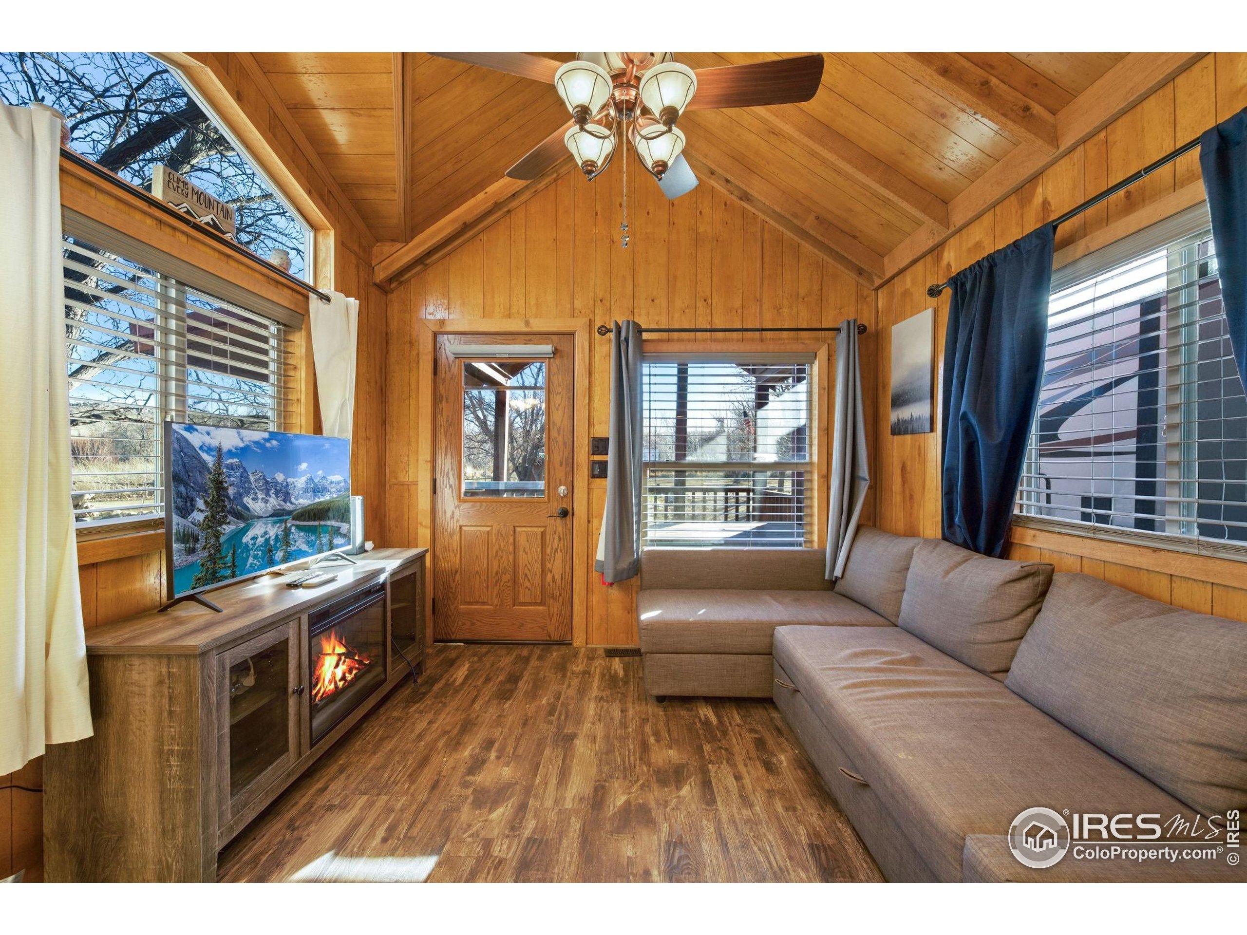2444 River Rim Road, Unit 417 Loveland, CO 80537 - Photo 12 of 21 a living room with furniture and a flat screen tv
