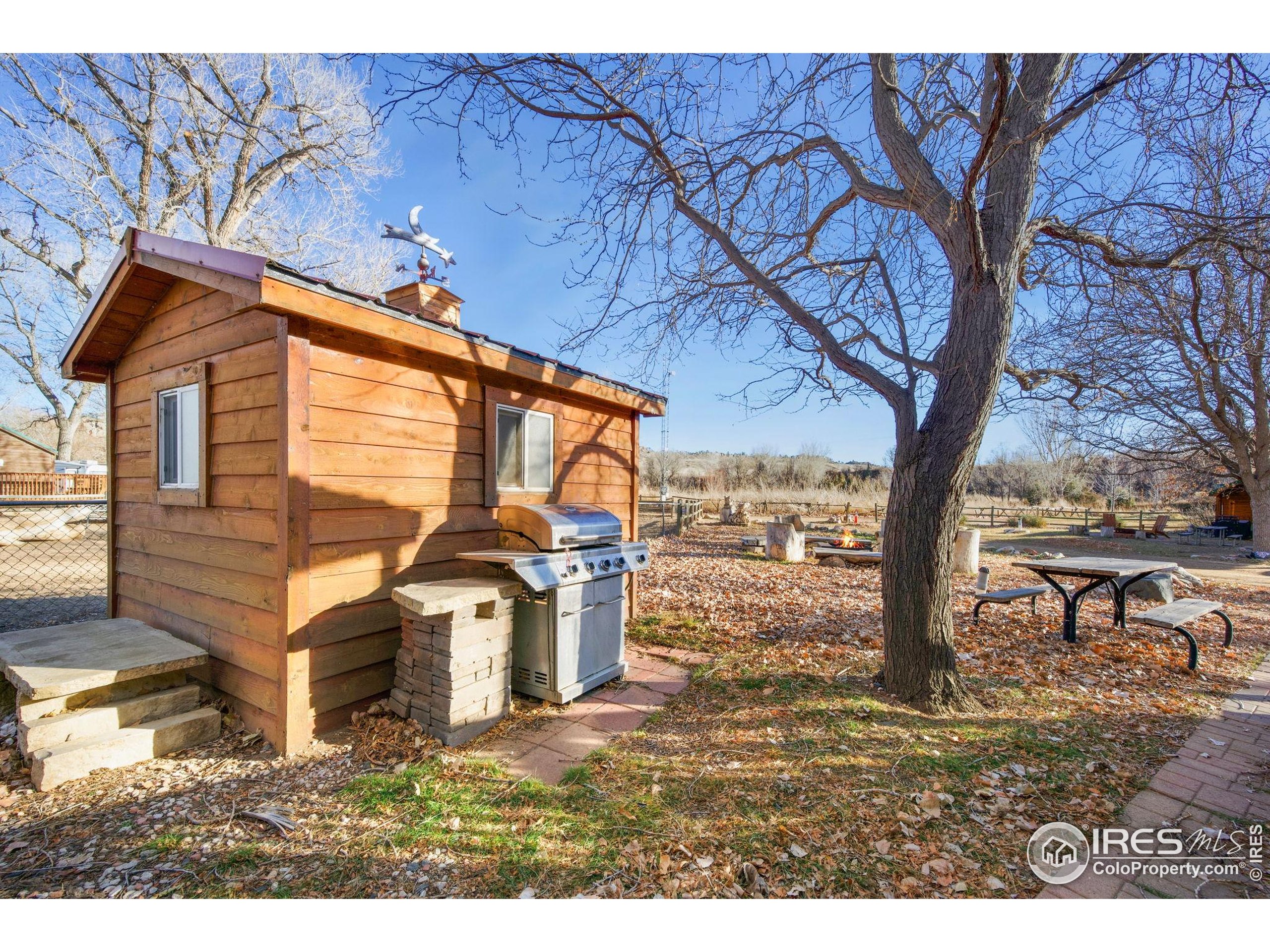 2444 River Rim Road, Unit 417 Loveland, CO 80537 - Photo 16 of 21 a view of a house with a yard