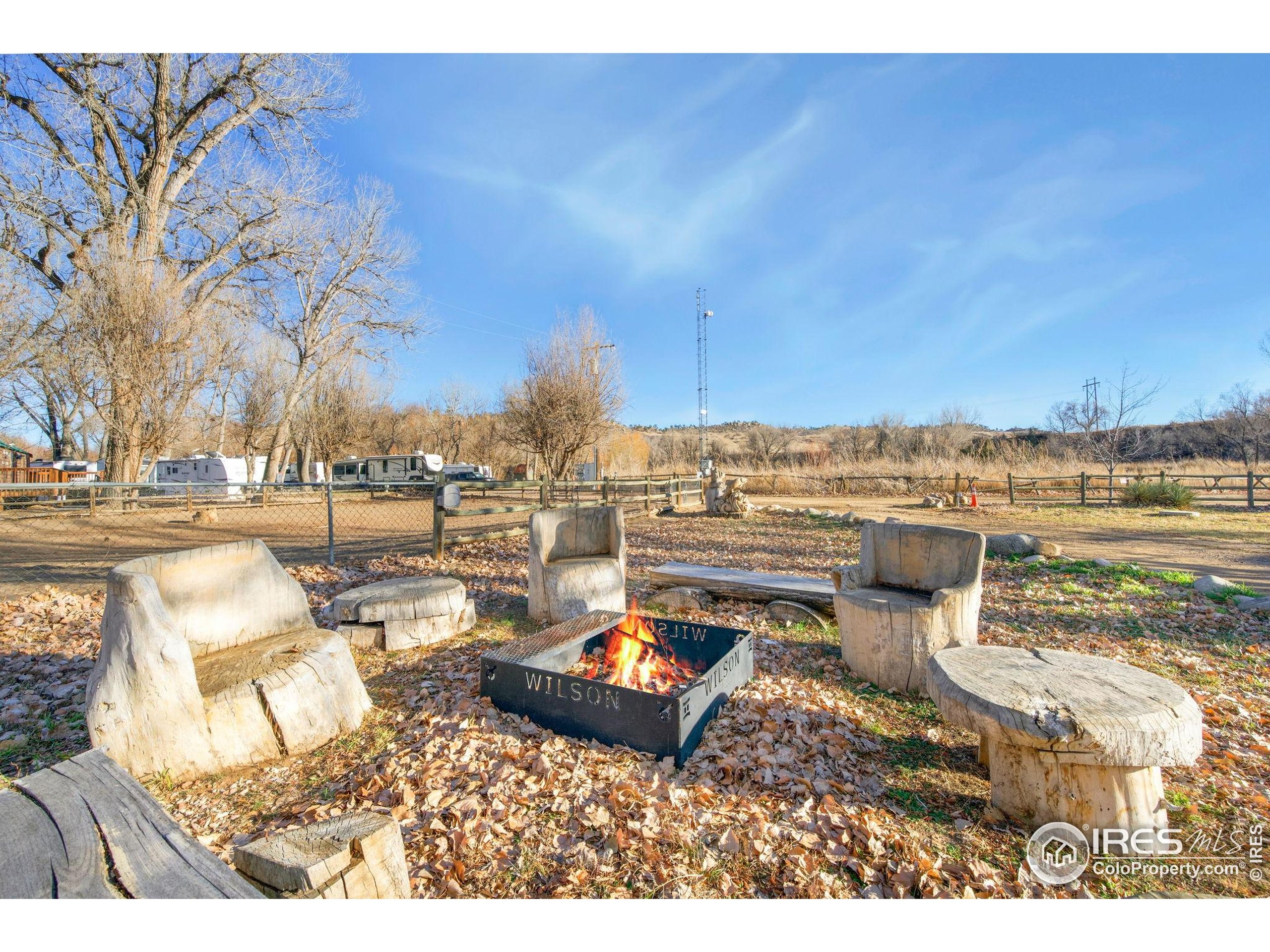 2444 River Rim Road, Unit 417 Loveland, CO 80537 - Photo 17 of 21 a backyard of a house with table and chairs