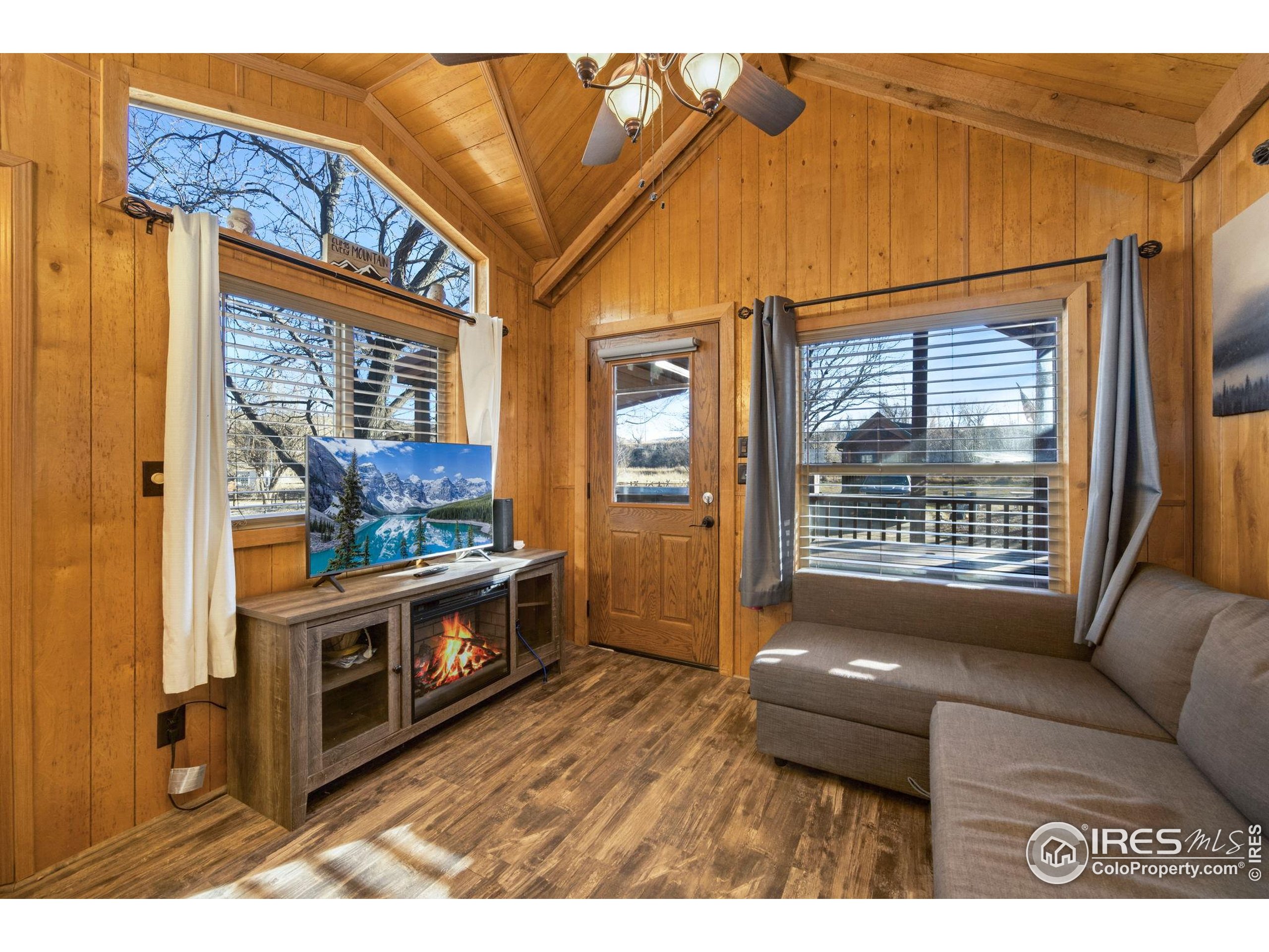 2444 River Rim Road, Unit 417 Loveland, CO 80537 - Photo 8 of 21 a living room with furniture and a flat screen tv