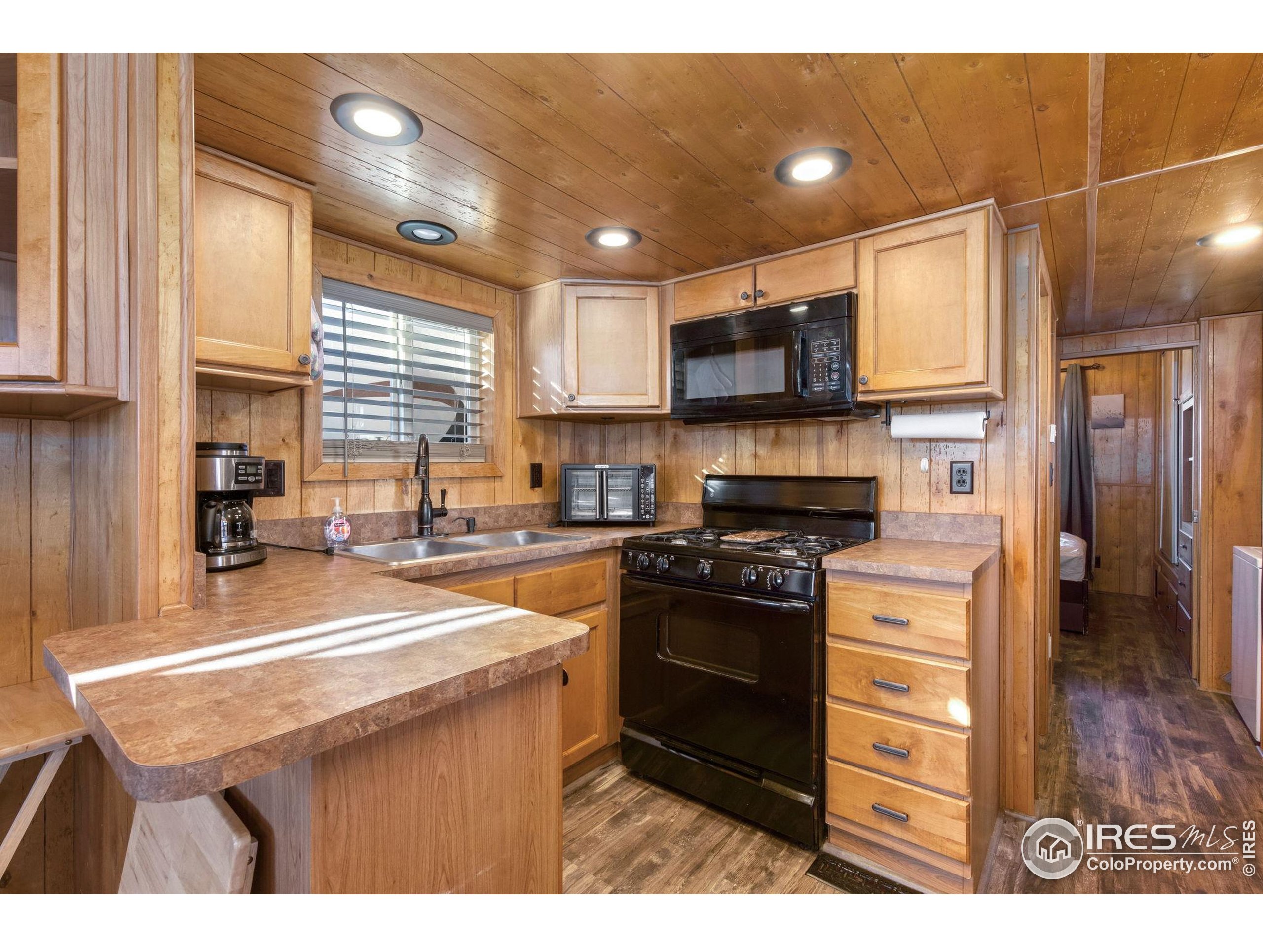 2444 River Rim Road, Unit 417 Loveland, CO 80537 - Photo 9 of 21 a kitchen with stainless steel appliances granite countertop a sink stove and refrigerator