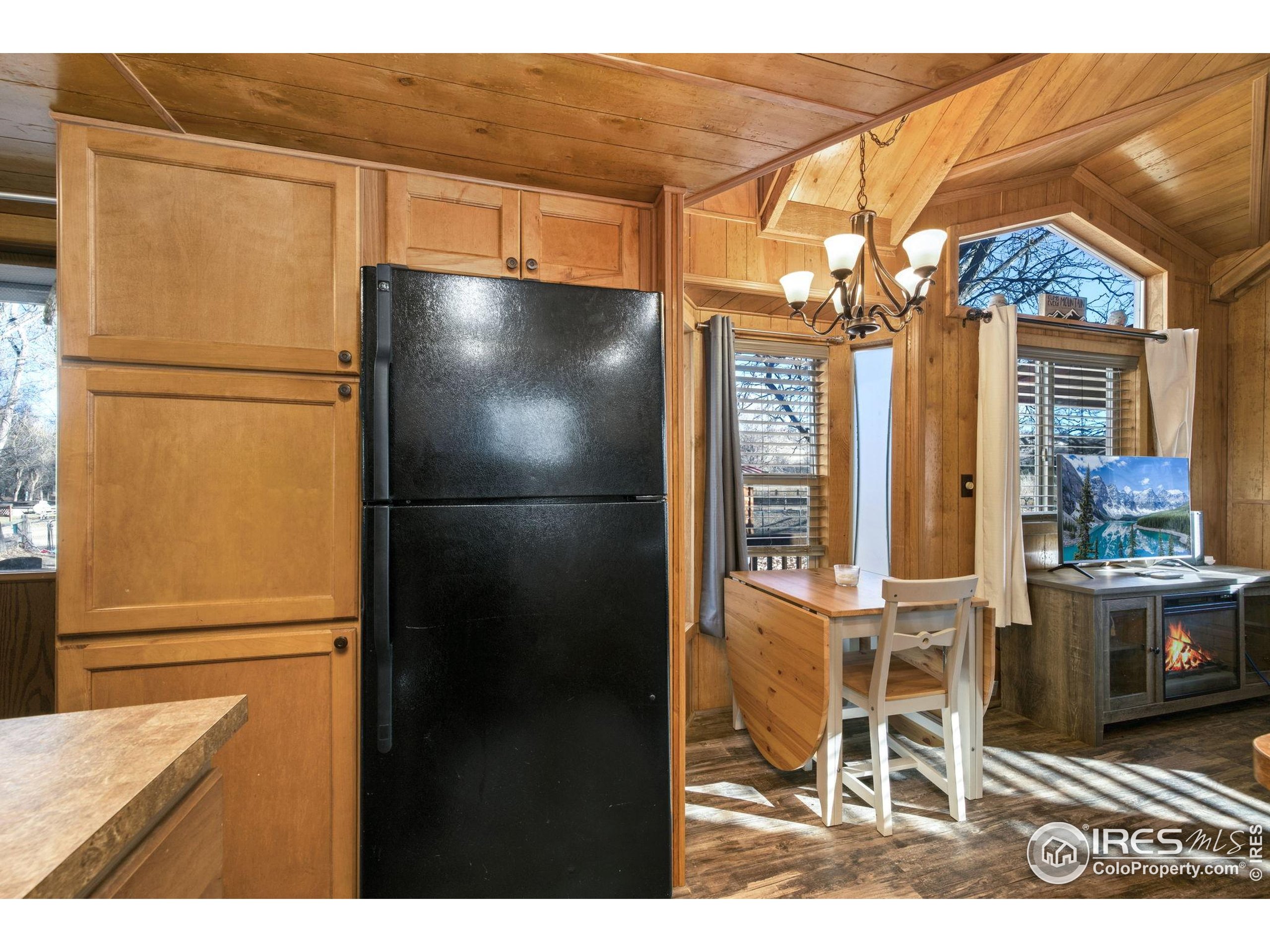 2444 River Rim Road, Unit 417 Loveland, CO 80537 - Photo 10 of 21 a view of a kitchen with a refrigerator and microwave