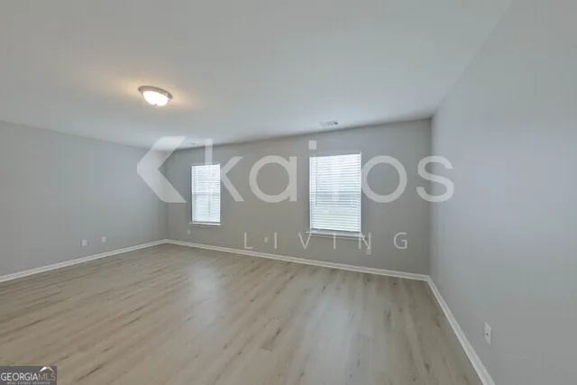 a view of room with window and wooden floor