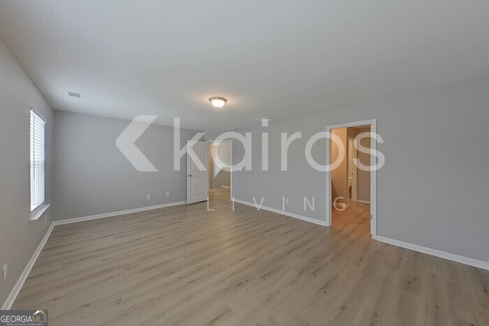 105 Colonial Way Springfield, GA 31329 - Photo 16 of 30 a view of an empty room with wooden floor and a window