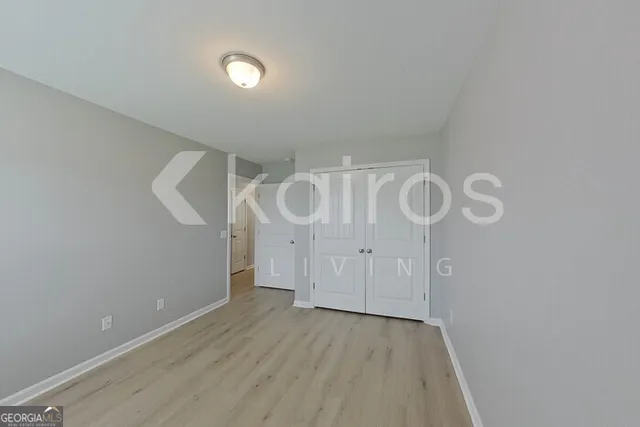a view of a room with wooden floor and white walls