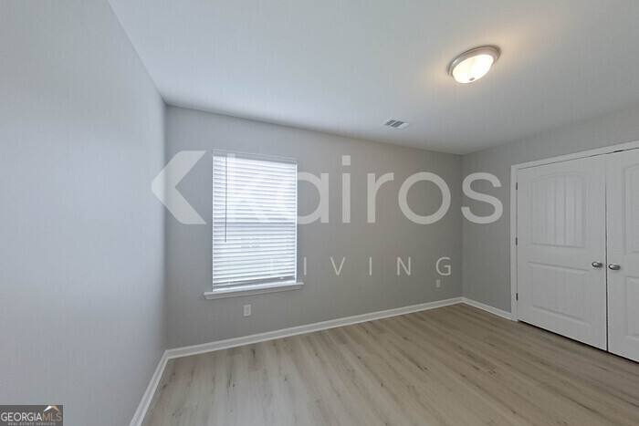 105 Colonial Way Springfield, GA 31329 - Photo 20 of 30 an empty room with wooden floor and windows
