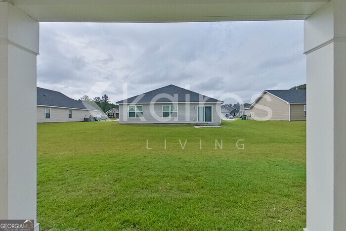105 Colonial Way Springfield, GA 31329 - Photo 26 of 30 a house view with swimming pool in front of it