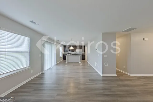 a view of a room with wooden floor