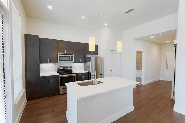 a kitchen with stainless steel appliances a refrigerator and a stove