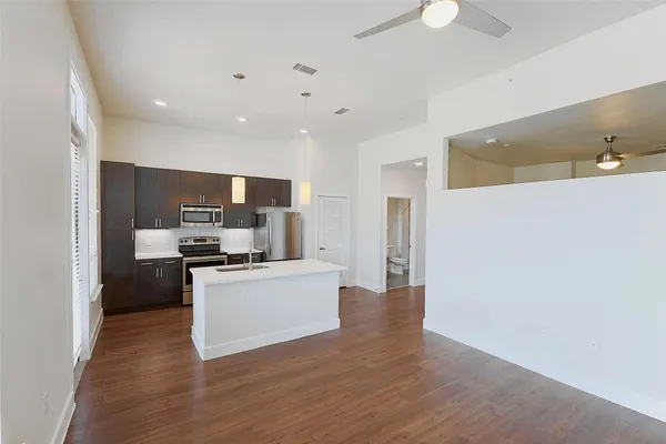 a kitchen with stainless steel appliances a refrigerator and a stove top oven