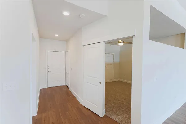 a kitchen with a sink and wooden floor
