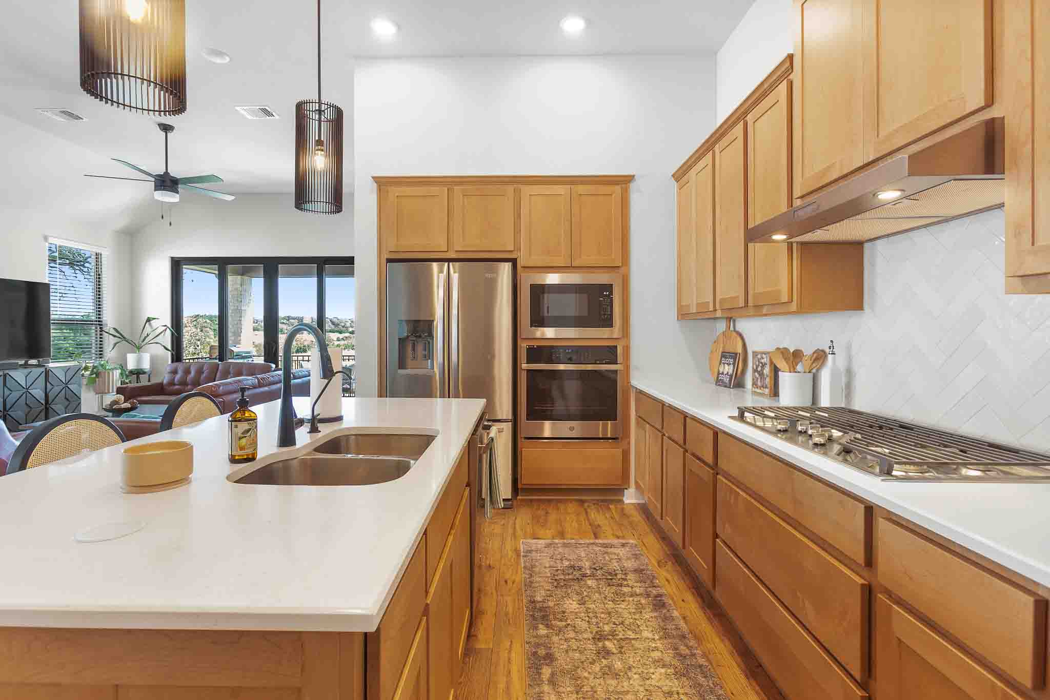 220 Basket Flower Loop Kyle, TX 78640 - Photo 10 of 40 Culinary excellence awaits in this well-appointed kitchen, featuring a spacious island and top-tier appliances.