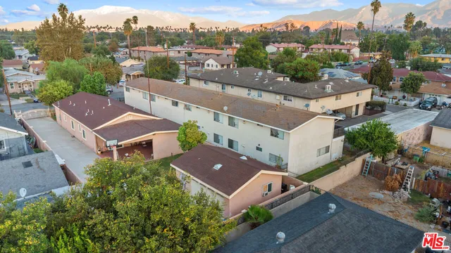 an aerial view of multiple houses with a yard