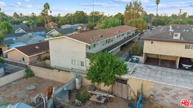 an aerial view of a house with a yard garage and lake view