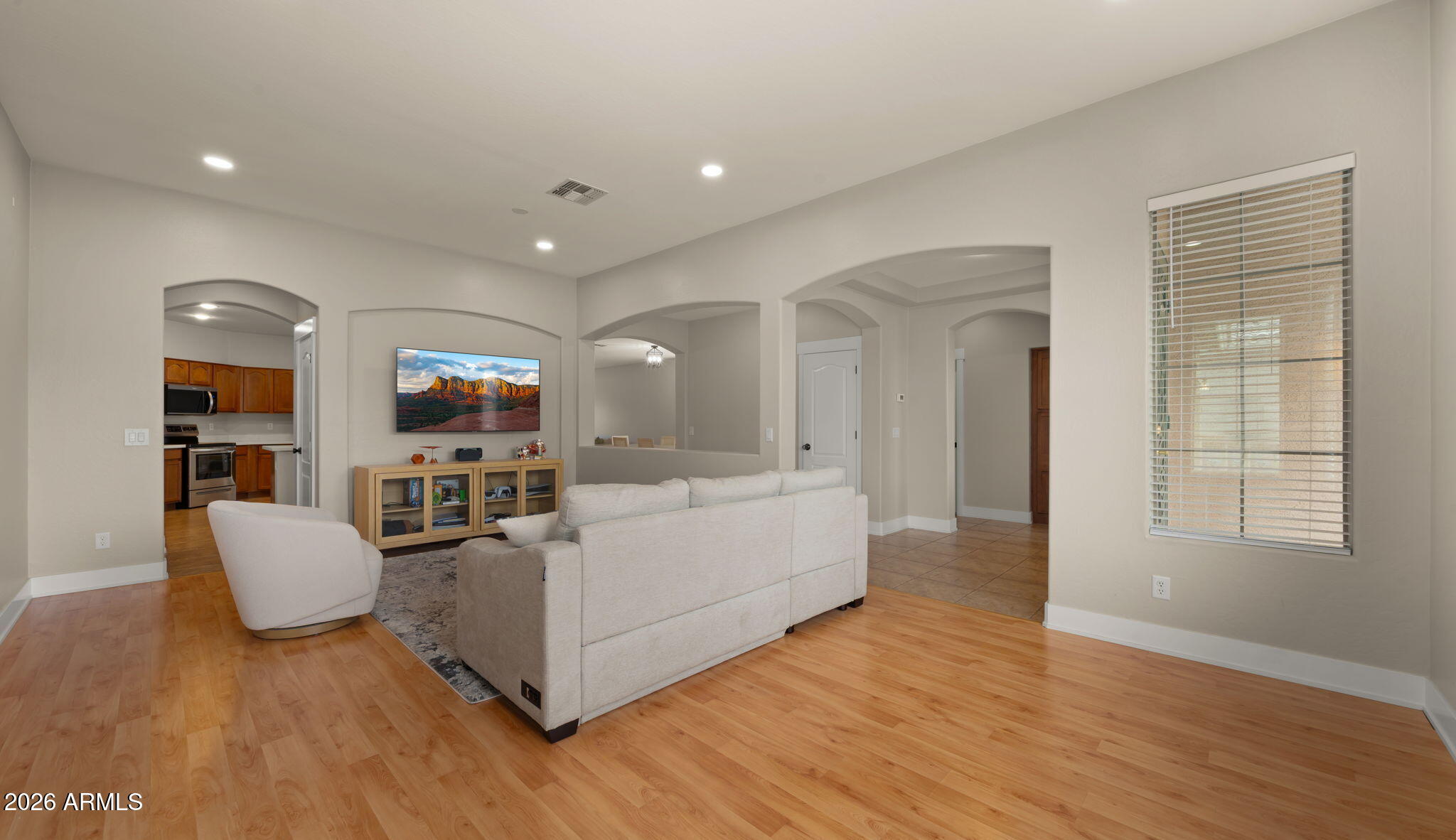 3344 East Hopkins Road Gilbert, AZ 85295 - Photo 12 of 32 a living room with furniture windows and a flat screen tv