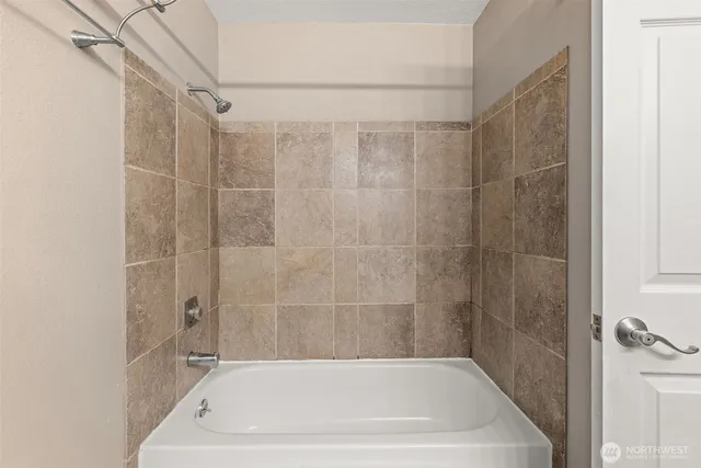 an empty room with a chandelier fan