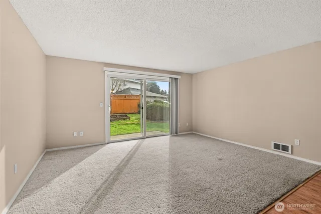 a kitchen with stainless steel appliances granite countertop a sink stove microwave and refrigerator