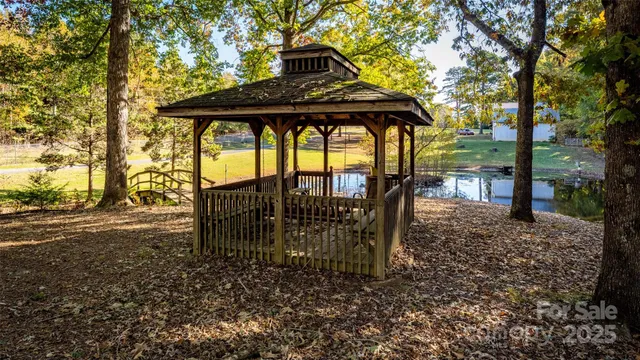 a view of a porch with a table chairs and a barbeque