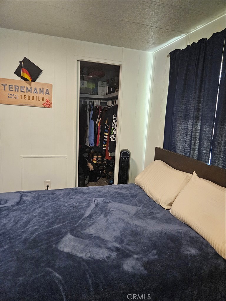 3825 Valley Boulevard, Unit 25 Walnut, CA 91789 - Photo 12 of 13 a bedroom with a bed and a dresser