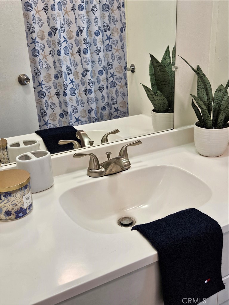3825 Valley Boulevard, Unit 25 Walnut, CA 91789 - Photo 14 of 15 a bathroom with a sink and a mirror