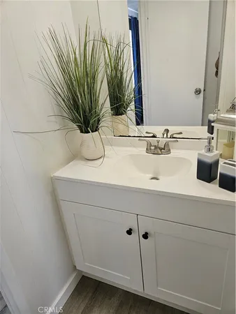 a bathroom with a sink a mirror and vanity
