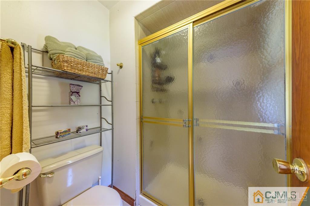 34 Lemon Road Farmingdale, NJ 07727 - Photo 25 of 29 a bathroom with a shower mirror and toilet