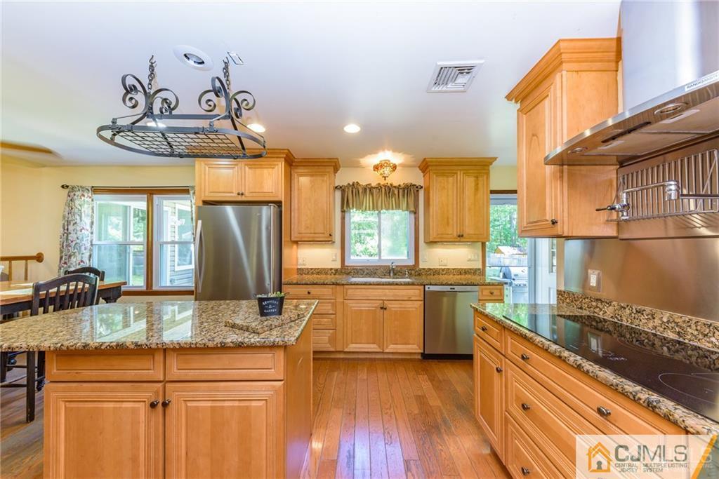 34 Lemon Road Farmingdale, NJ 07727 - Photo 9 of 29 a kitchen with counter top space and wooden floor