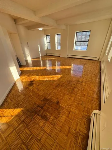 a view of an entryway with wooden floor