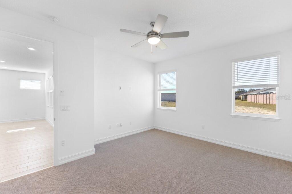 3320 Northwest 52nd Avenue Road Ocala, FL 34482 - Photo 16 of 25 an empty room with a window and a fan