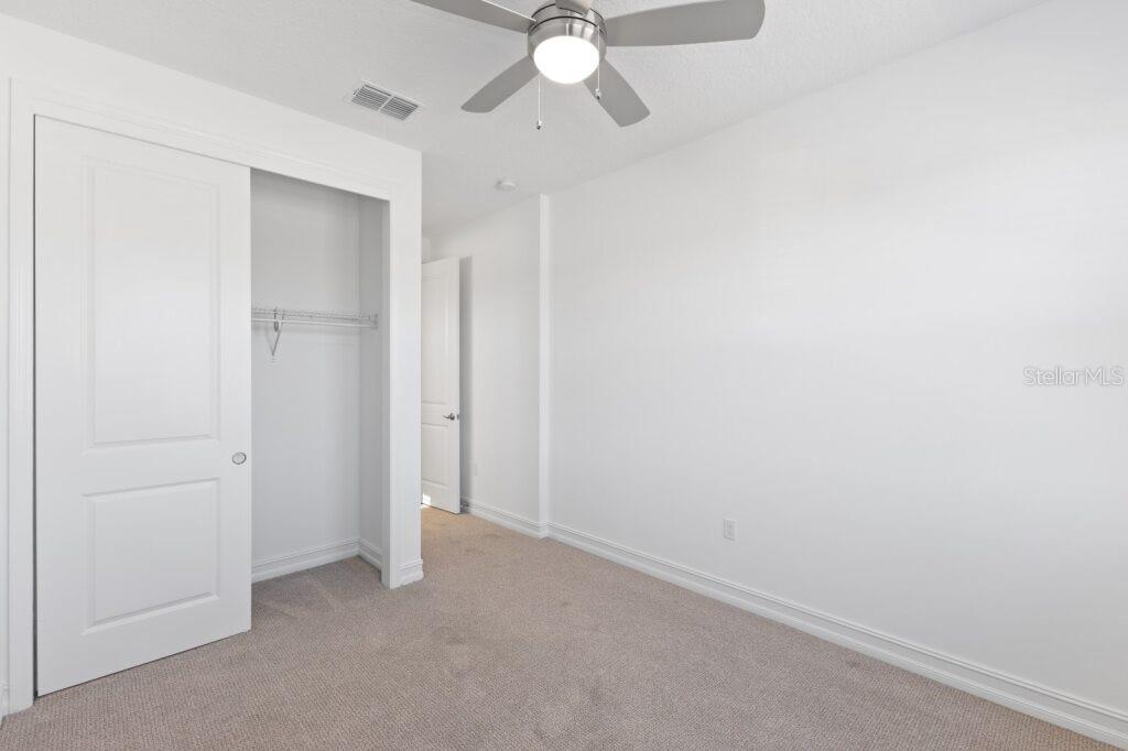 3320 Northwest 52nd Avenue Road Ocala, FL 34482 - Photo 21 of 25 an empty room with closet and a chandelier fan