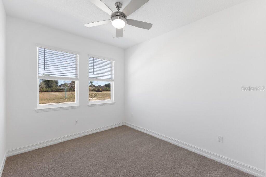 3320 Northwest 52nd Avenue Road Ocala, FL 34482 - Photo 22 of 25 an empty room with a window and a fan