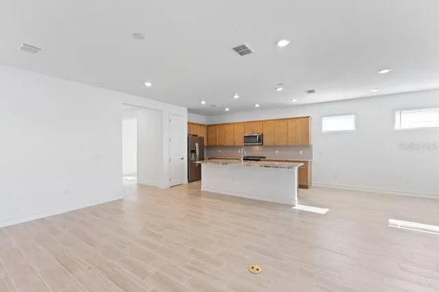 a view of kitchen with white cabinets